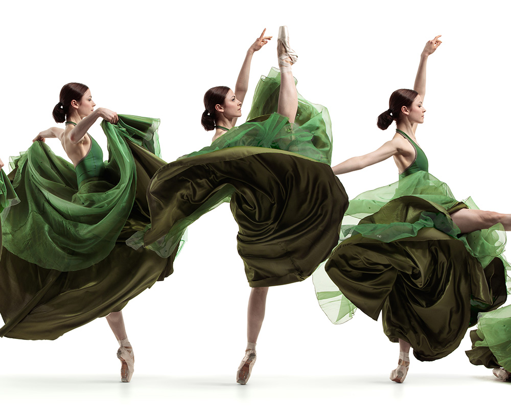 Three ballet dancers in flowing green dresses captured mid-leap — a Motions sequence